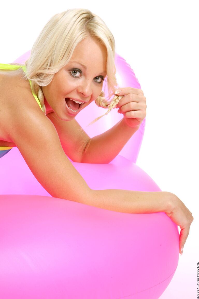 15P Cute blonde Sharka Blue tugs on her pigtails while working free of a bikini