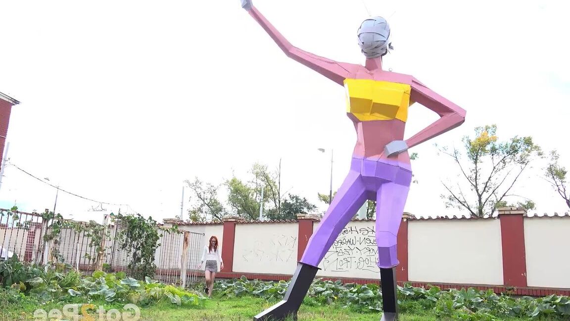 15P Gorgeous redhead squats and pees near a sculpture