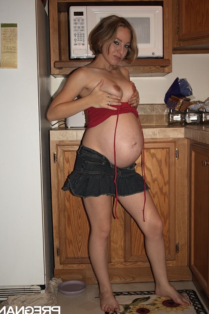 16P Kristi, une amatrice enceinte, montre ses fesses avant de jouer avec sa chatte dans la cuisine.