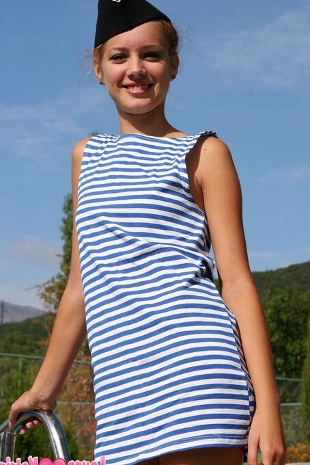 10P Cute teen flashes her underwear next to a swimming pool while wearing a cap