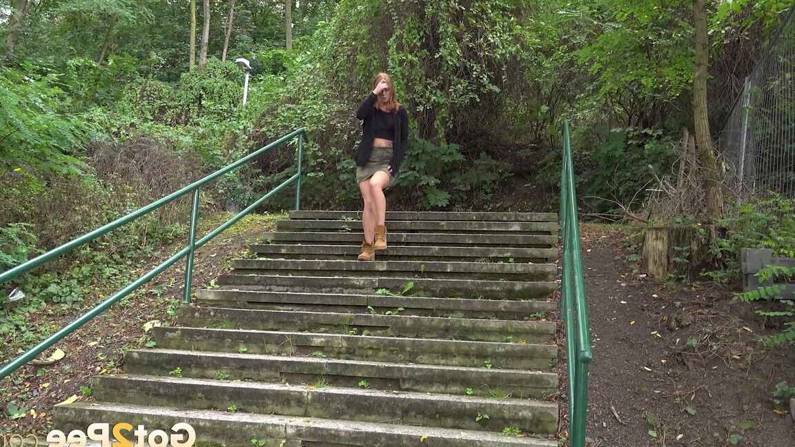 15P Natural redhead Chrissy Fox squats for a pee on a set of public steps