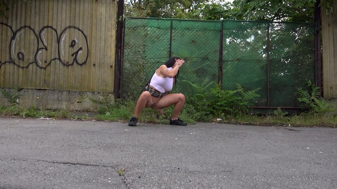 15P Distressed girl Isabel Dark takes a badly needed pee on a paved roadway