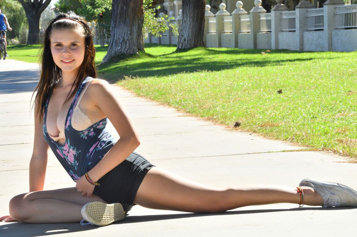 21P Sexy black haired girl Desiree rubs her twat and runs in a bra in the park