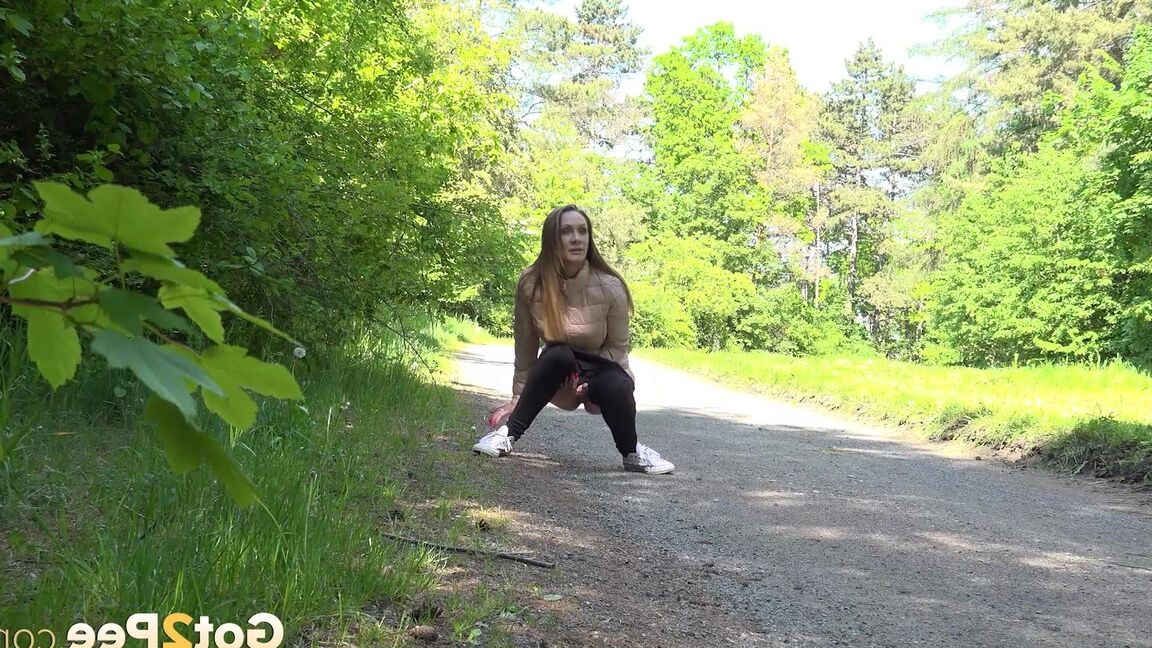15P Euro girl Cynthia Vellons pulls down her pants to take a piss on a gravel path