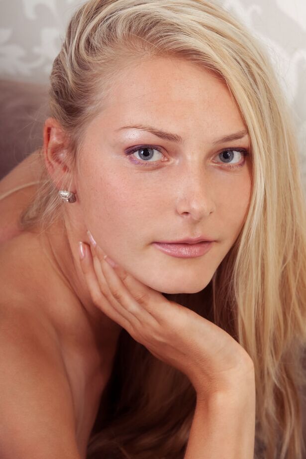 18P Young blond Denisa Kate doffs a bra and thong set before showing her nice twat