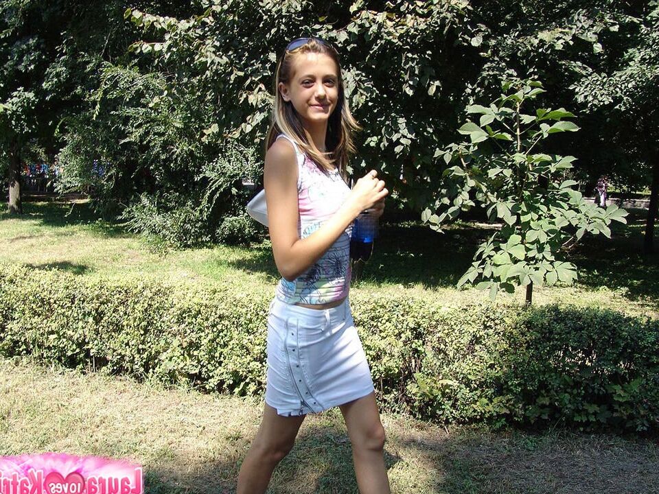 12P Young looking girl sports a no panty upskirt while at a park