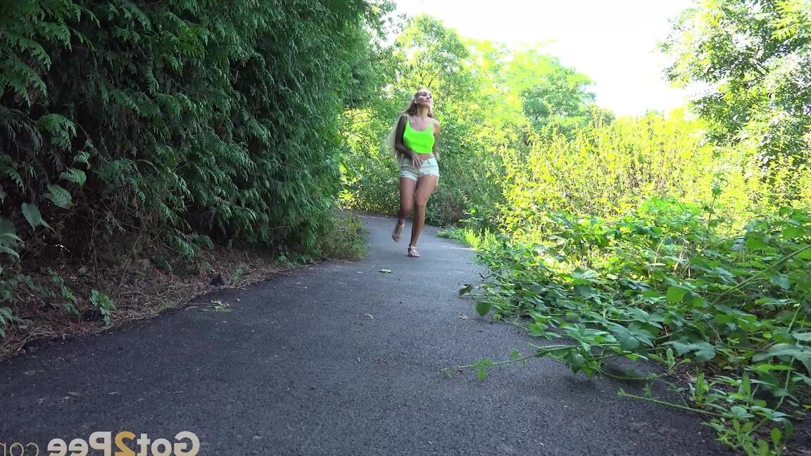 15P Blonde teen Daisy Lee takes a piss on a paved path through the woods