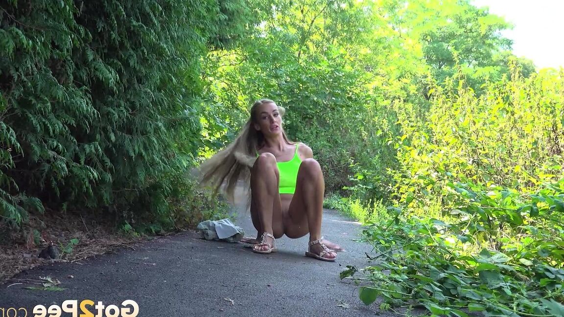 15P Blonde teen Daisy Lee takes a piss on a paved path through the woods