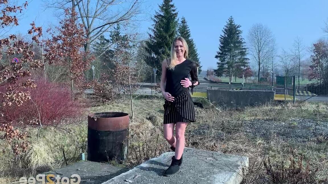 15P Blonde chick Claudia Macc squats for a piss on a concrete pad in black UGGs