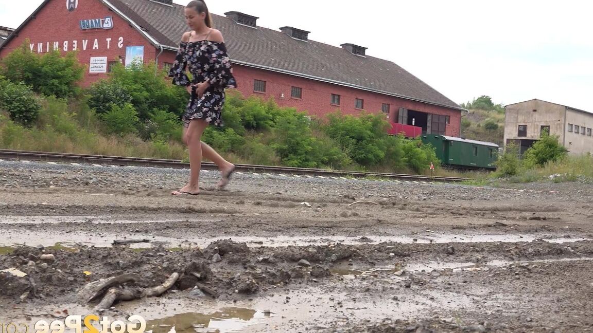 15P Sexy brunette Yenna squats and pees in a puddle
