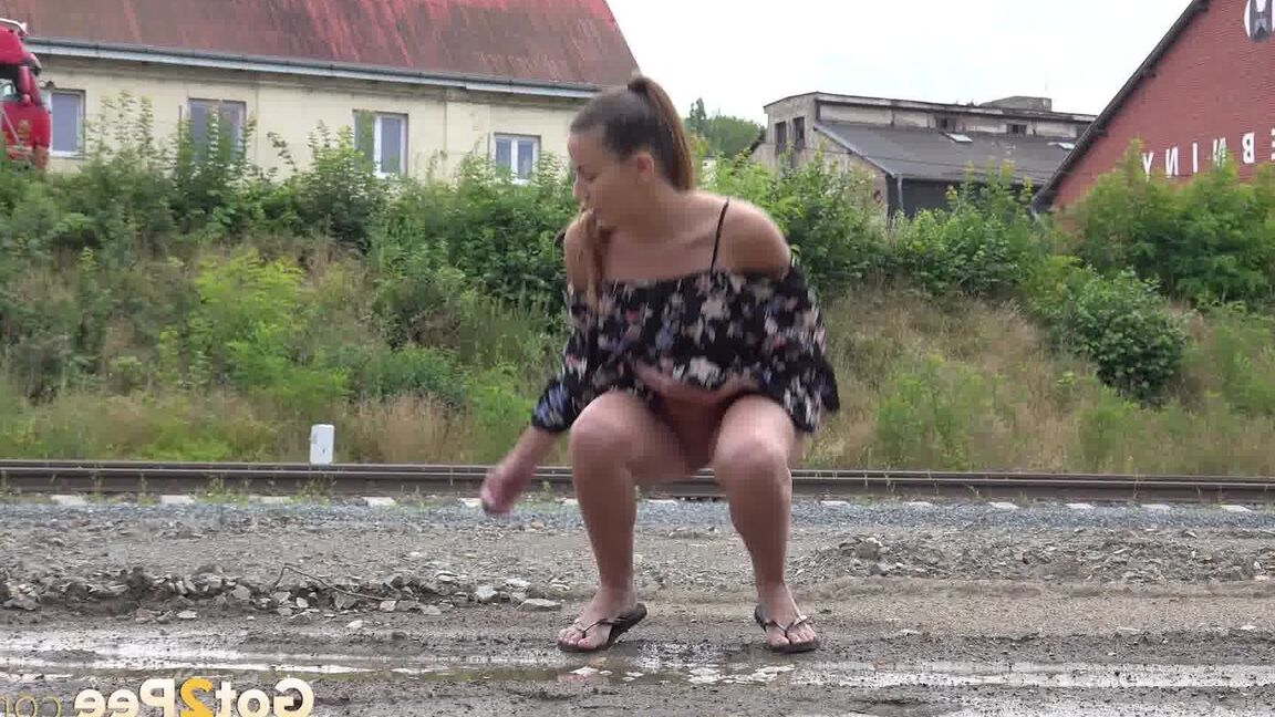 15P Sexy brunette Yenna squats and pees in a puddle