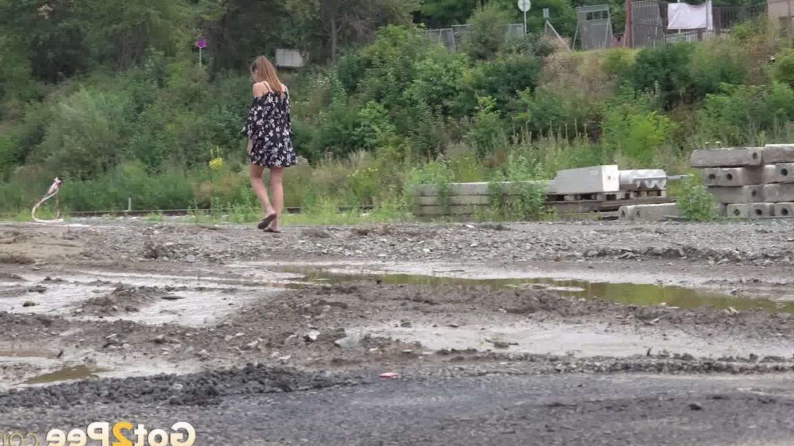 15P Sexy brunette Yenna squats and pees in a puddle