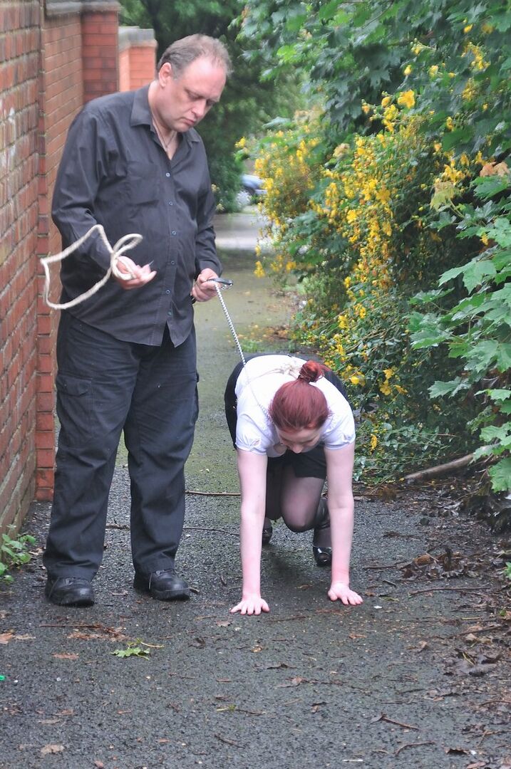 16P Redhead licks her Master's boots in parking lot before crawling on all fours