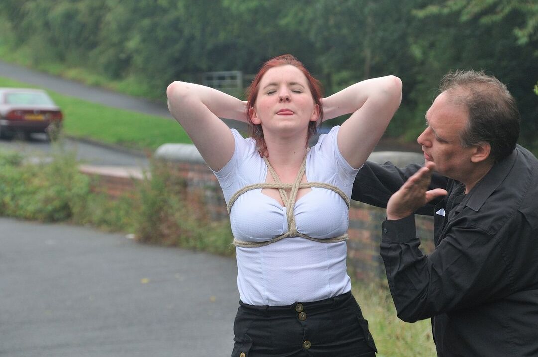 16P Redhead licks her Master's boots in parking lot before crawling on all fours