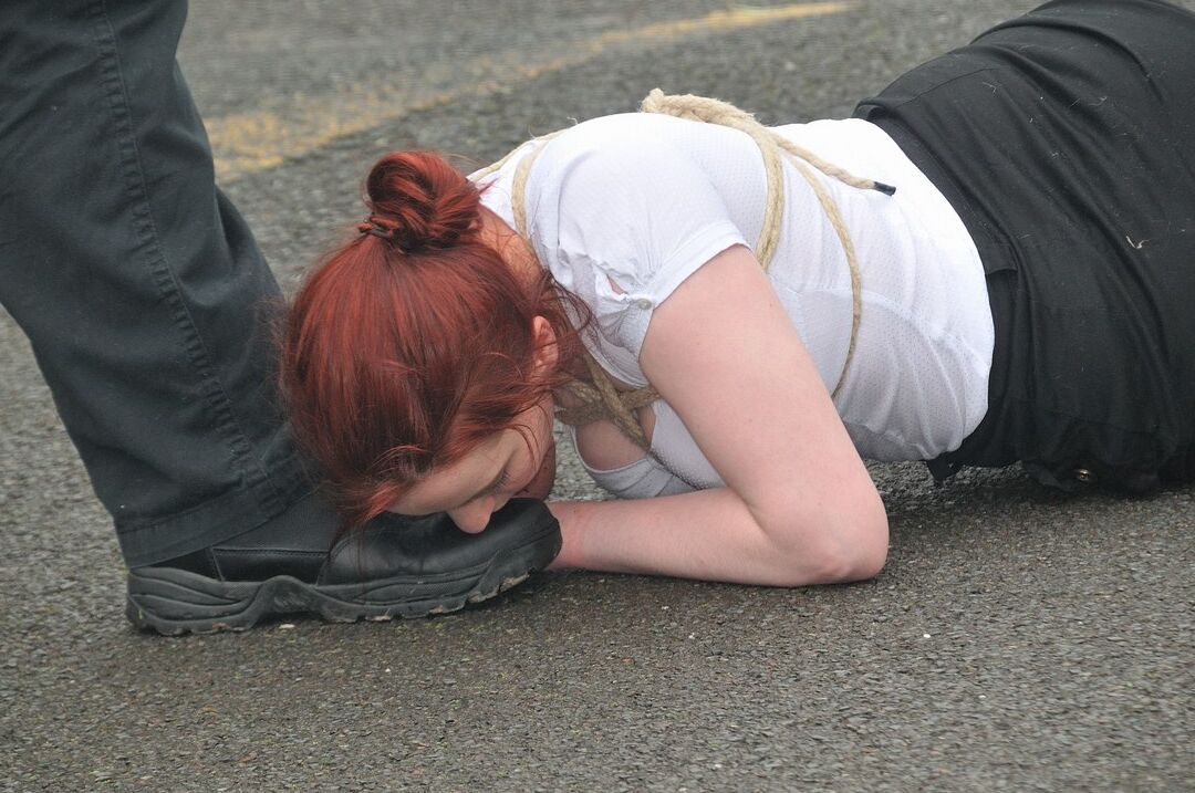 16P Redhead licks her Master's boots in parking lot before crawling on all fours