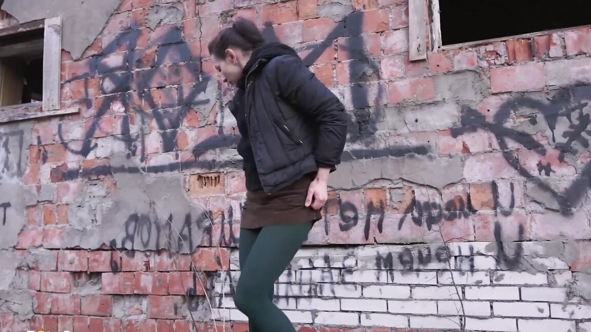 15P Caucasian girl pulls down her tights for a piss behind an abandoned building