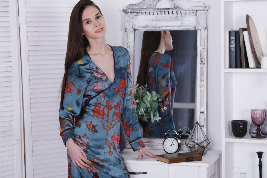 12P Leona Mia admires herself in the mirror as she pulls open her satin dress to