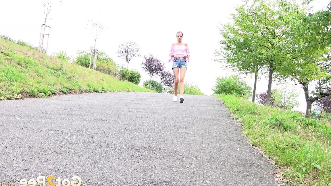 15P Leggy girl Mistika takes a piss on a paved path after being caught short taken