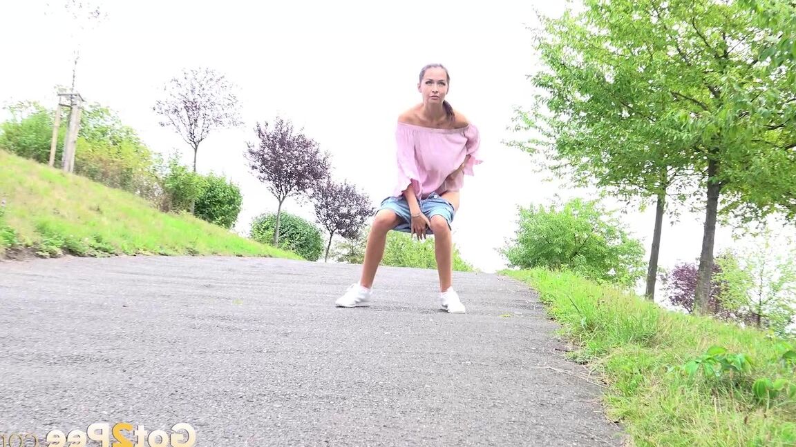 15P Leggy girl Mistika takes a piss on a paved path after being caught short taken