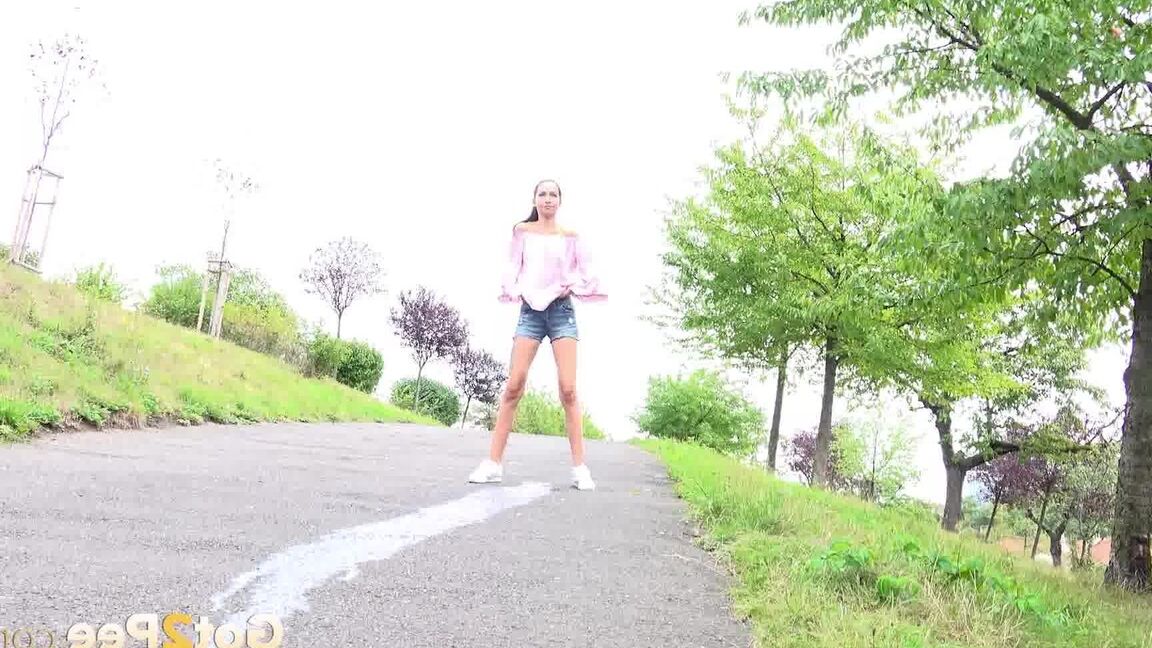 15P Leggy girl Mistika takes a piss on a paved path after being caught short taken