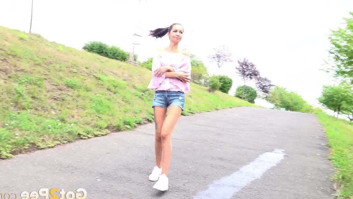 15P Leggy girl Mistika takes a piss on a paved path after being caught short taken