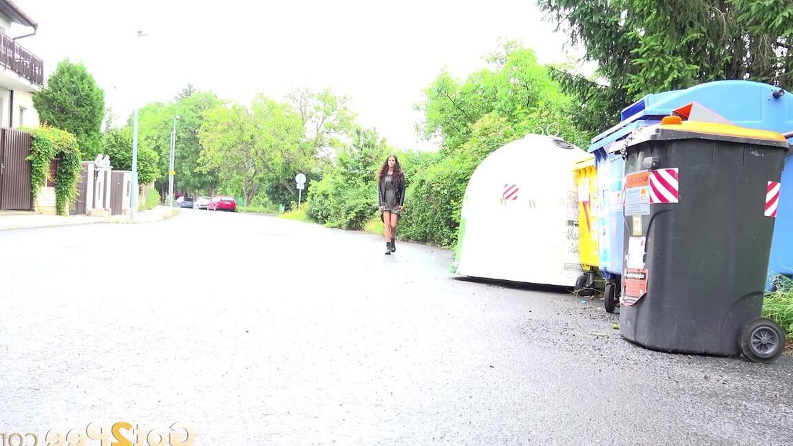 15P Short taken girl Ali Bordeaux squats for a piss on a road by refuse containers