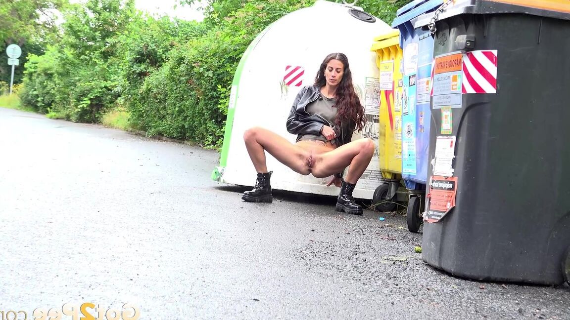 15P Short taken girl Ali Bordeaux squats for a piss on a road by refuse containers