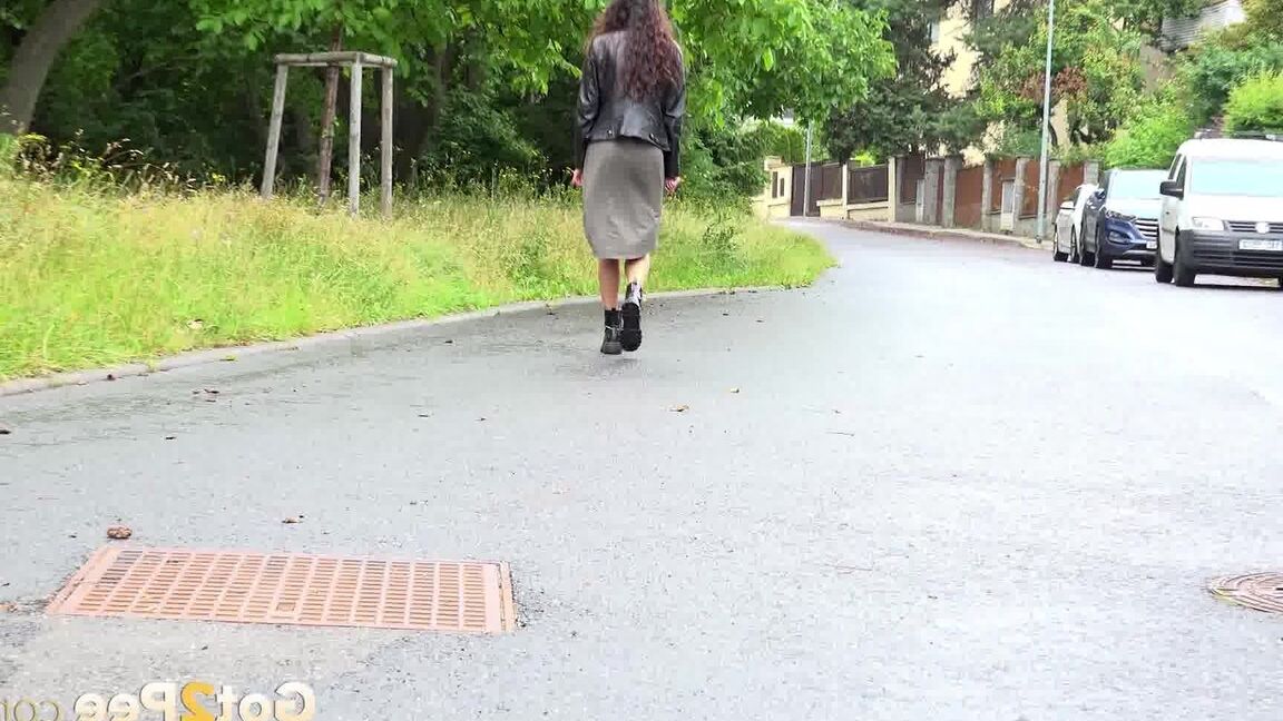 15P Short taken girl Ali Bordeaux squats for a piss on a road by refuse containers