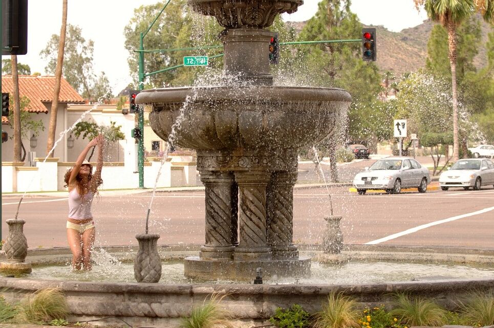 21P Sweet curly haired redhead Ashley exposes her big booty on a public fountain
