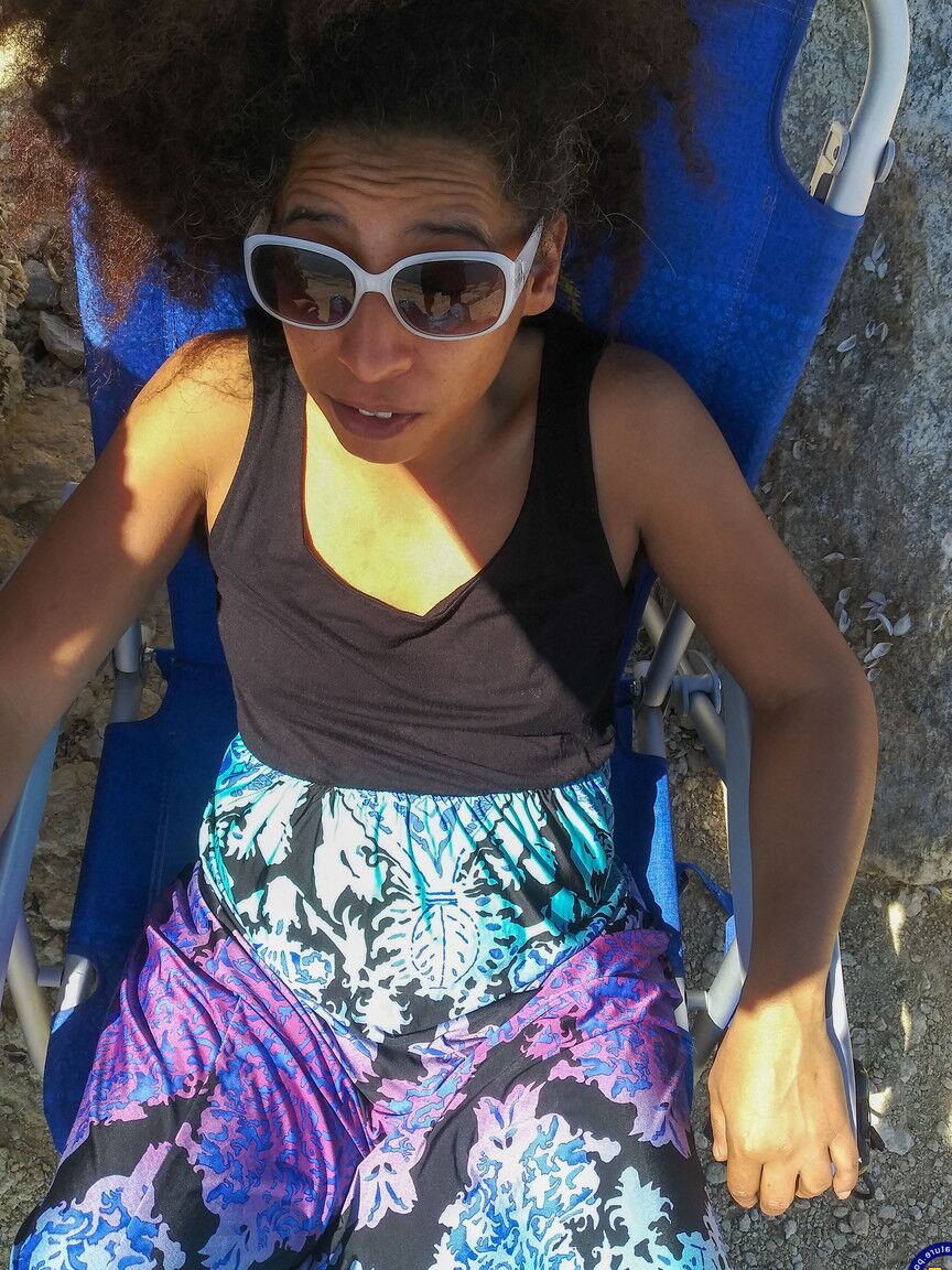 21P Mature ebony with hairy armpits Divine reveals her bushy cunt on the beach