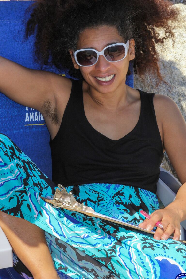 21P Mature ebony with hairy armpits Divine reveals her bushy cunt on the beach