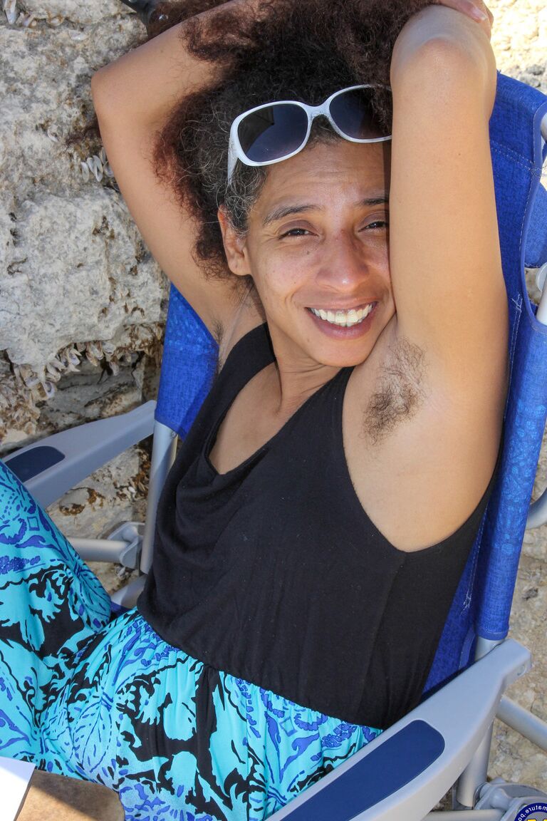 21P Mature ebony with hairy armpits Divine reveals her bushy cunt on the beach