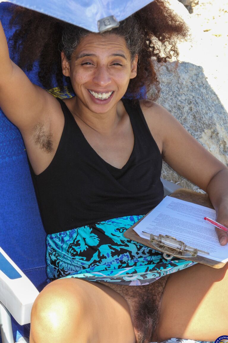 21P Mature ebony with hairy armpits Divine reveals her bushy cunt on the beach