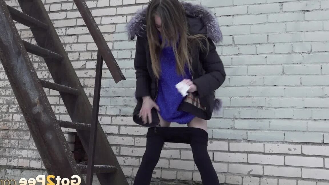 15P Caucasian girl pulls down her leggings to take a piss on snow-covered ground
