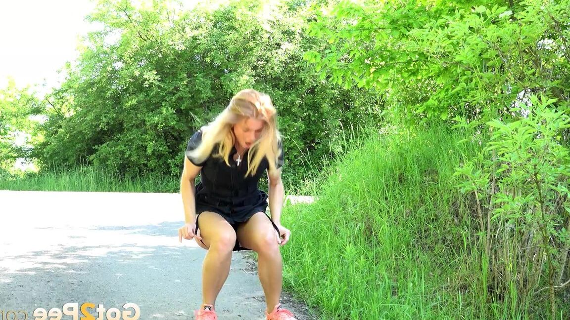 15P Blonde Chrissy squats to take a pee in the middle of the walking path