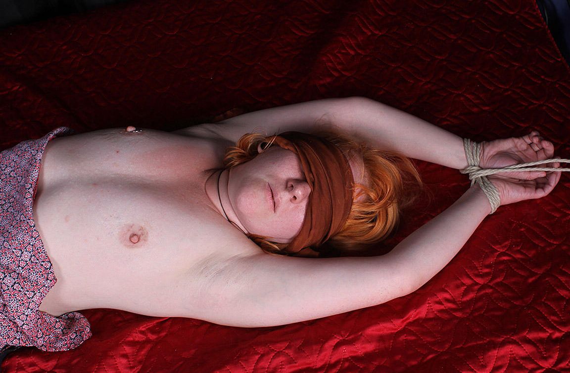 16P Pale redhead Florence is blindfolded while restrained with rope on a bed