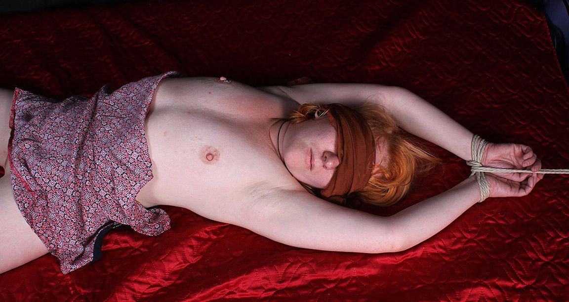 16P Pale redhead Florence is blindfolded while restrained with rope on a bed