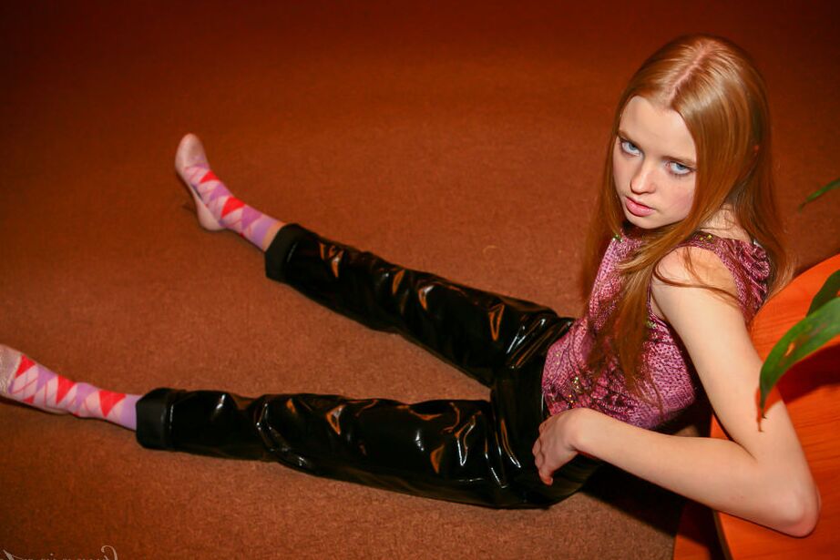 16P Young redhead Avril A exposes her tits and ass while wearing latex pants