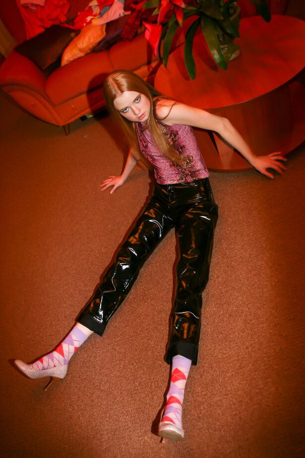 16P Young redhead Avril A exposes her tits and ass while wearing latex pants