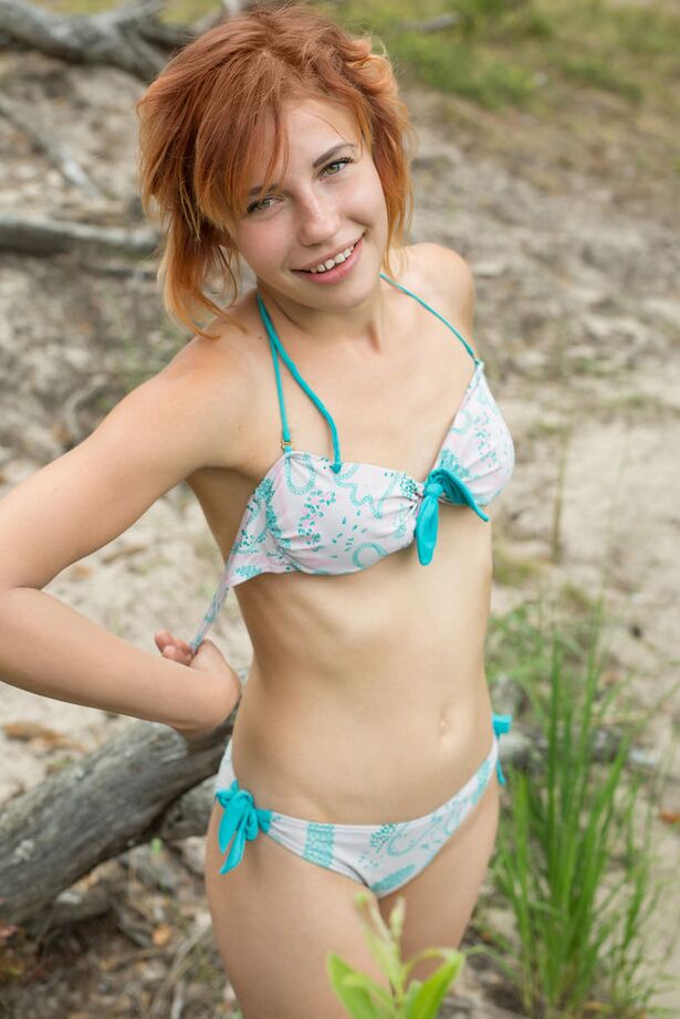 16P Young redhead Shannan takes off her bikini to pose naked near a stream