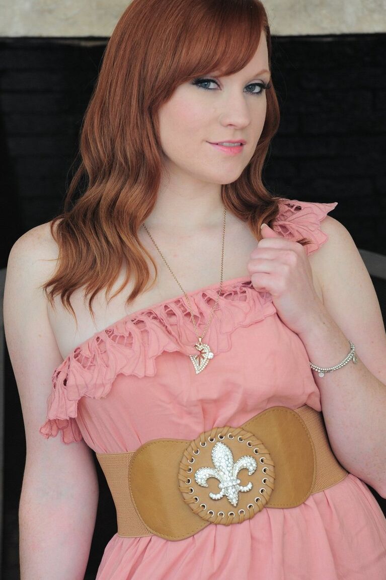 15P Hot redhead model Lucy OHara removes the ruffles to bare it all
