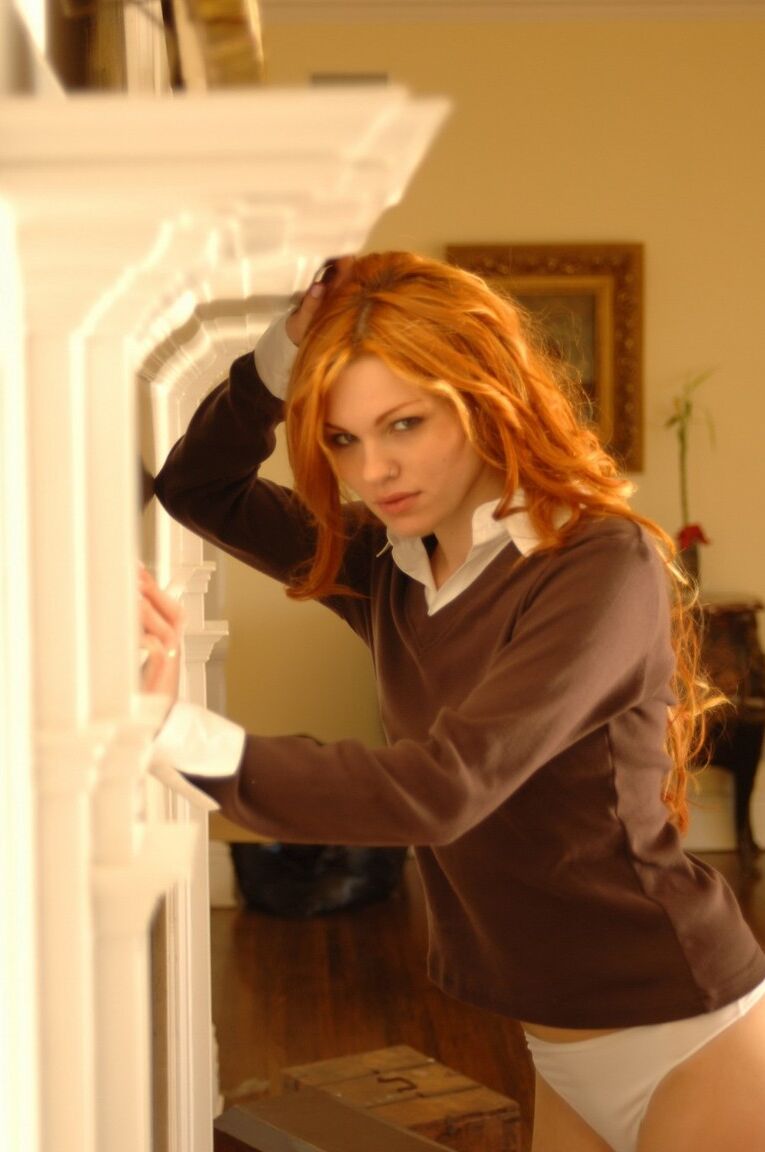 12P Sexy redhead Jamie Langford pulls down white upskirt panties afore fireplace