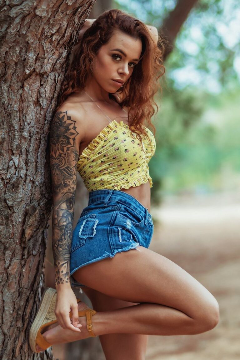 12P A amadora tatuada Mia Stryker fica nua ao lado de uma árvore de uma maneira sexy