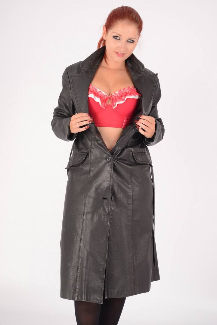 15P Natural redhead undoes a long leather coat to expose tan lined breasts