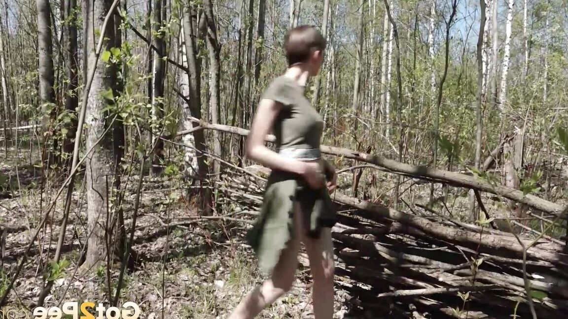 15P Caucasian girl Mariam takes a piss near a wattle fence in the woods