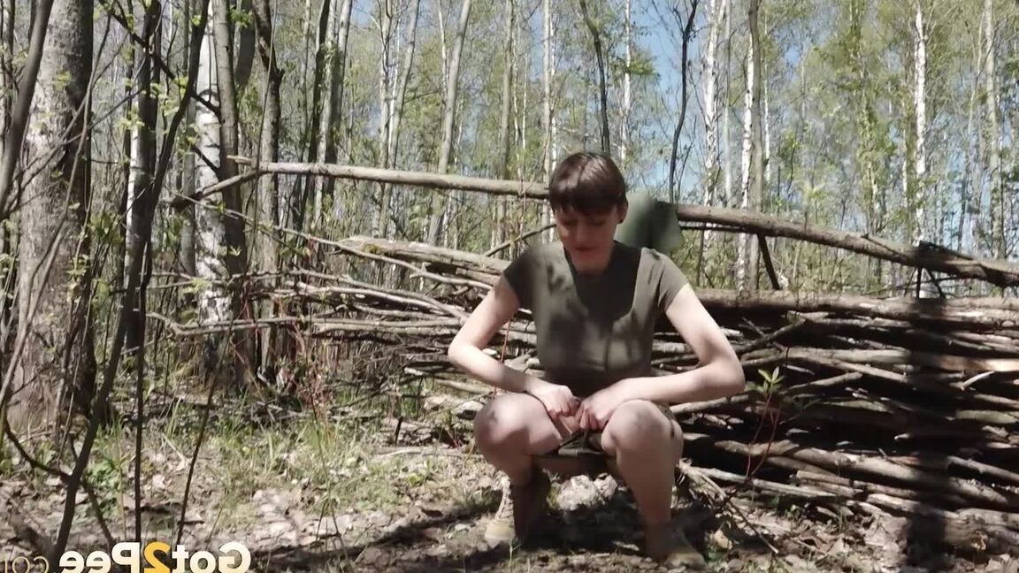 15P Caucasian girl Mariam takes a piss near a wattle fence in the woods