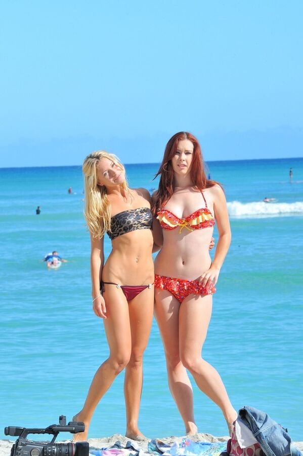 16P Lesbian lovers kiss at the beach prior to removing their bikinis