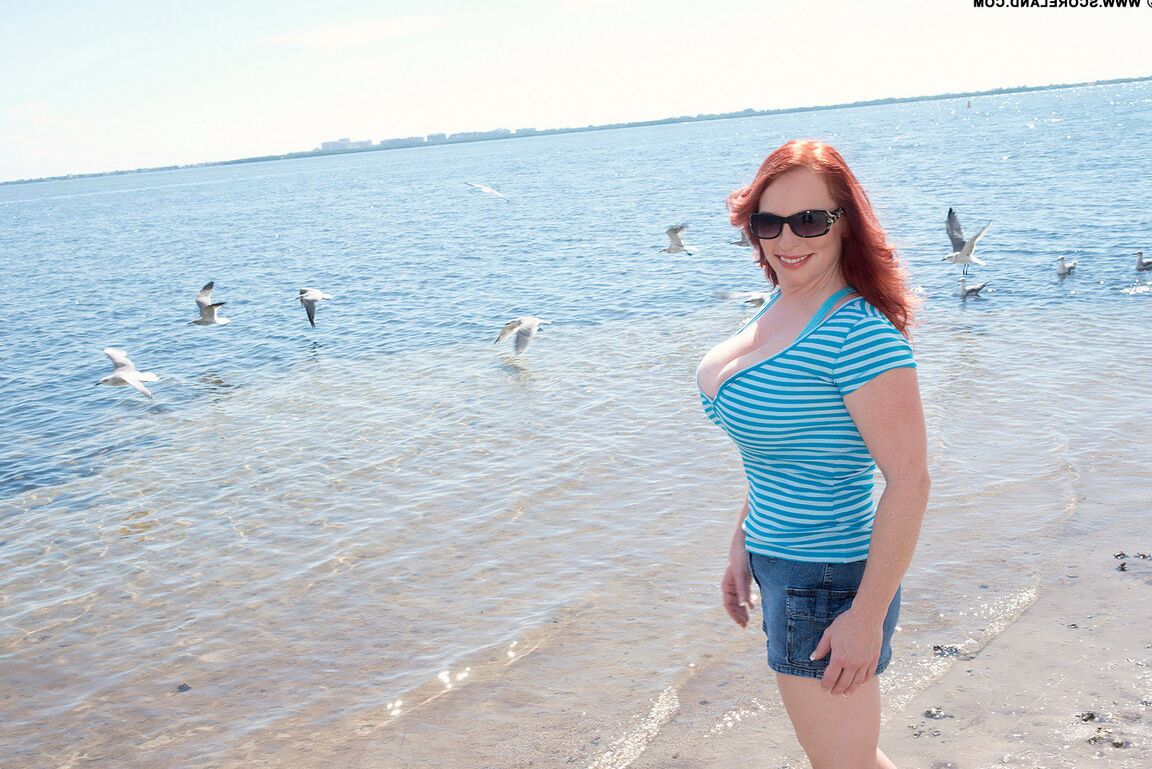 16P Natural redhead Red Vixen releases her big tits from a bathing suit in shades