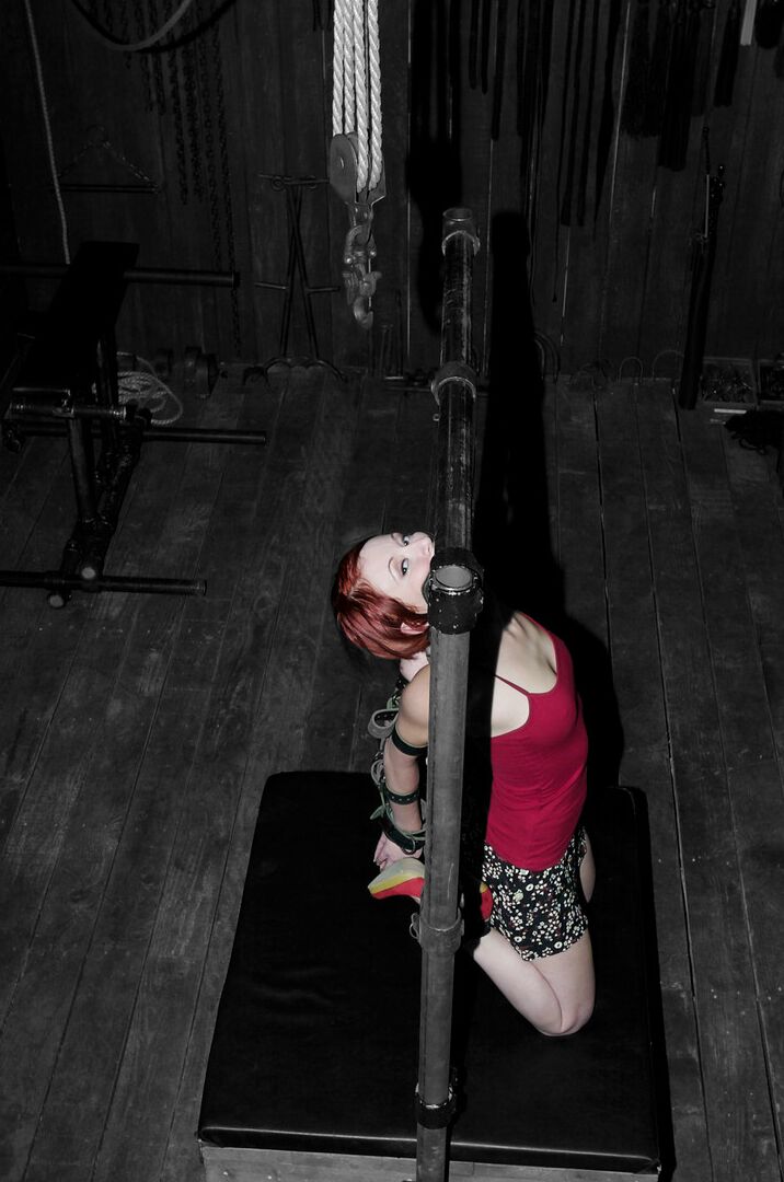 19P Redheaded MILF Sabrina Sparx gets stripped while tied to a metal construction