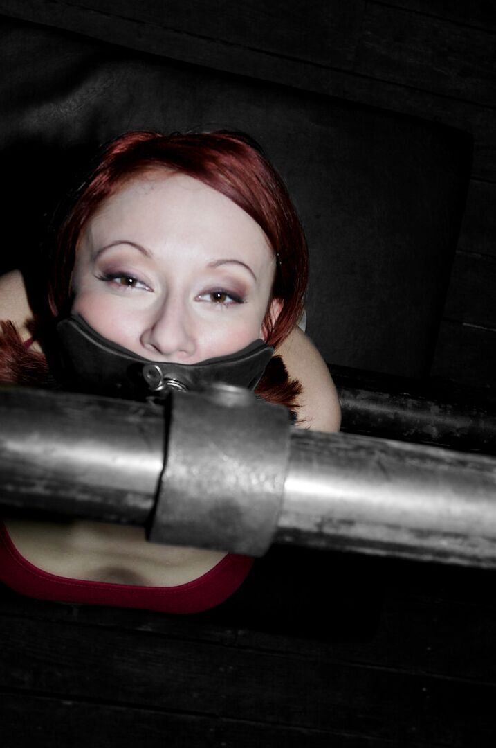 19P Redheaded MILF Sabrina Sparx gets stripped while tied to a metal construction